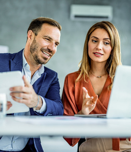 Man and woman analyzing financial data.