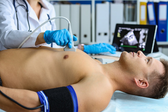 Ultrasound examination of man with ultrasound sensor.