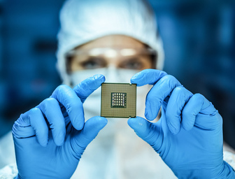 Person examining IC Substrate holding it in two hands.