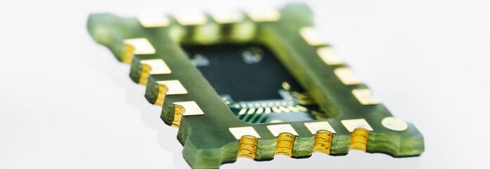 Multilayer rigid PCB with a cavity in the middle and castellations on the edges.